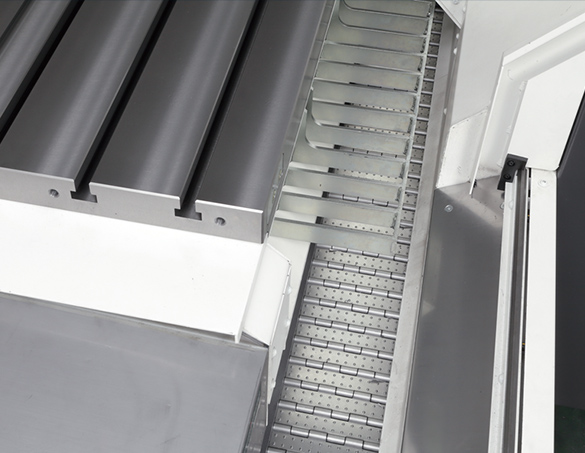 Wide in-machine hinged conveyors surround the table.Large chip volumes discharged smoothly
